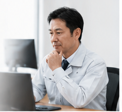 パソコンの前で状況を確認する会社経営者